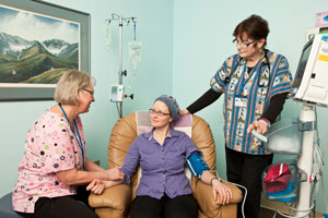 nurses with patient in treatment room