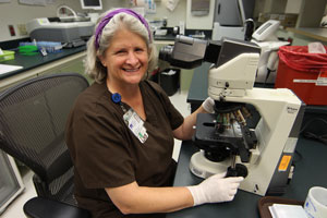 lab tech. using microscope