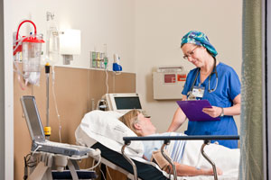 nurse with patient in hospital room