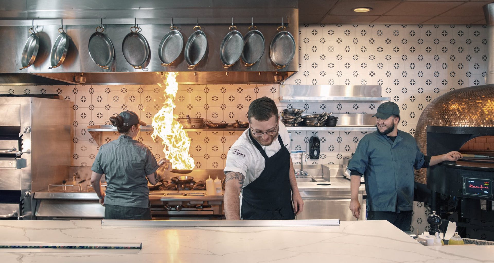 Three chefs working in a kitchen
